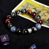 Gemstone bead bracelet featuring dark blue, amber, and red tones with silver clasp detail