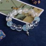 Faceted clear and light blue bead bracelet with gold cuffs and star charm