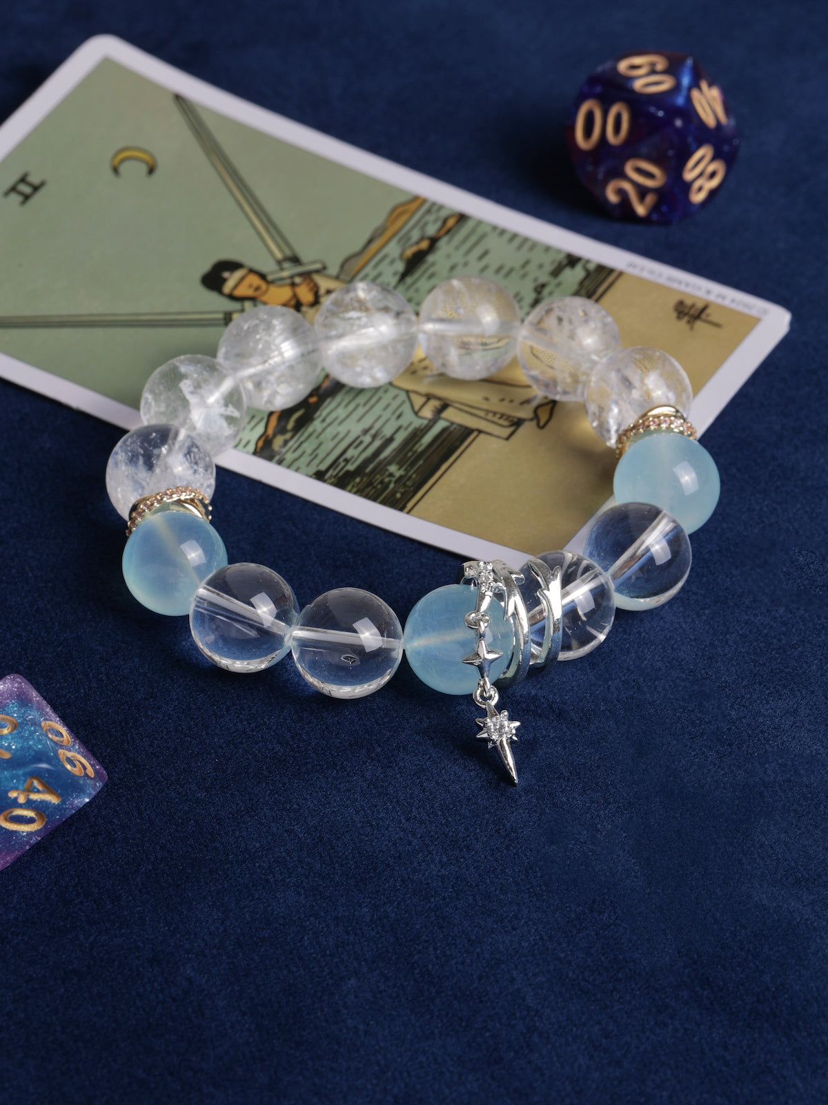Faceted clear and light blue bead bracelet with gold cuffs and star charm