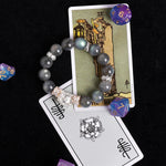 Gray bead stretch bracelet with ornate crystal cluster centerpiece and silver spacers