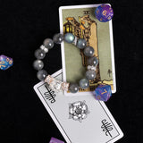 Gray bead stretch bracelet with ornate crystal cluster centerpiece and silver spacers