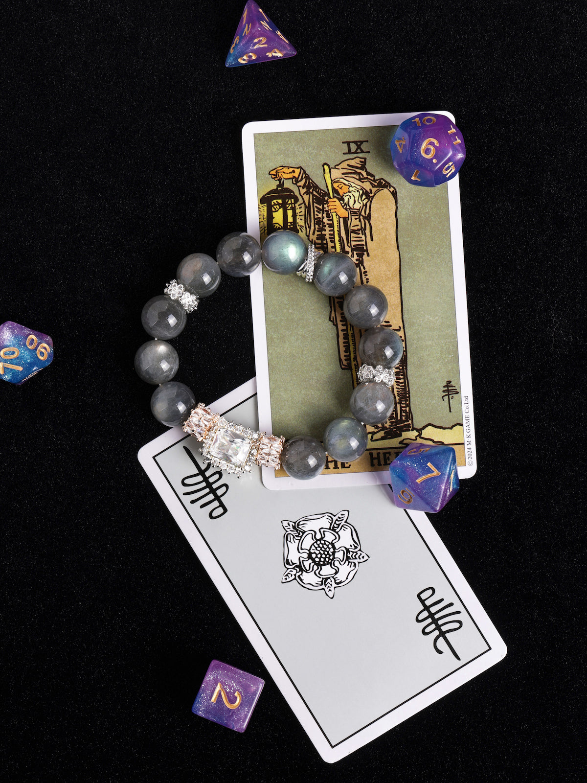 Gray bead stretch bracelet with ornate crystal cluster centerpiece and silver spacers