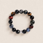 Beaded gemstone bracelet with dark round beads and silver spacer, stretch style.