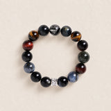 Beaded gemstone bracelet with dark round beads and silver spacer, stretch style.