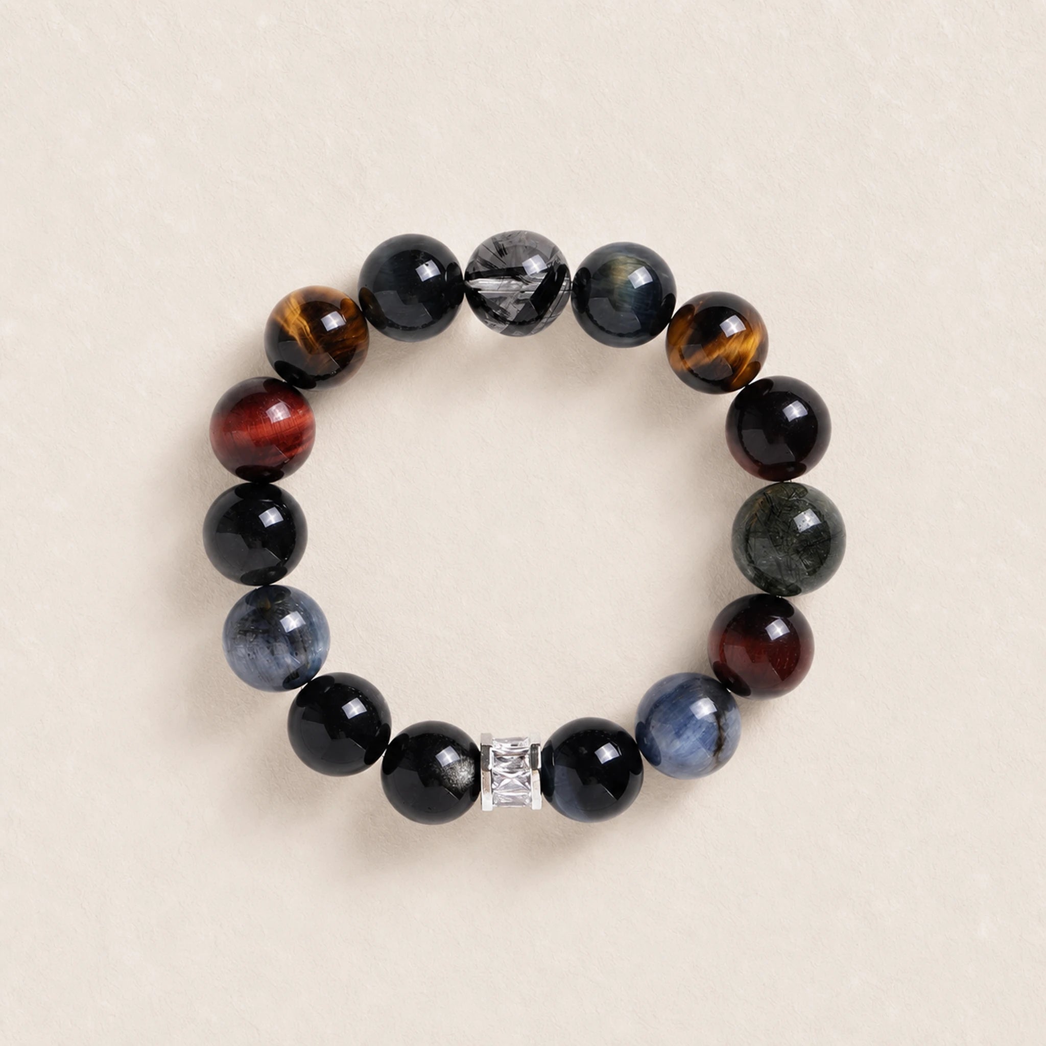 Beaded gemstone bracelet with dark round beads and silver spacer, stretch style.