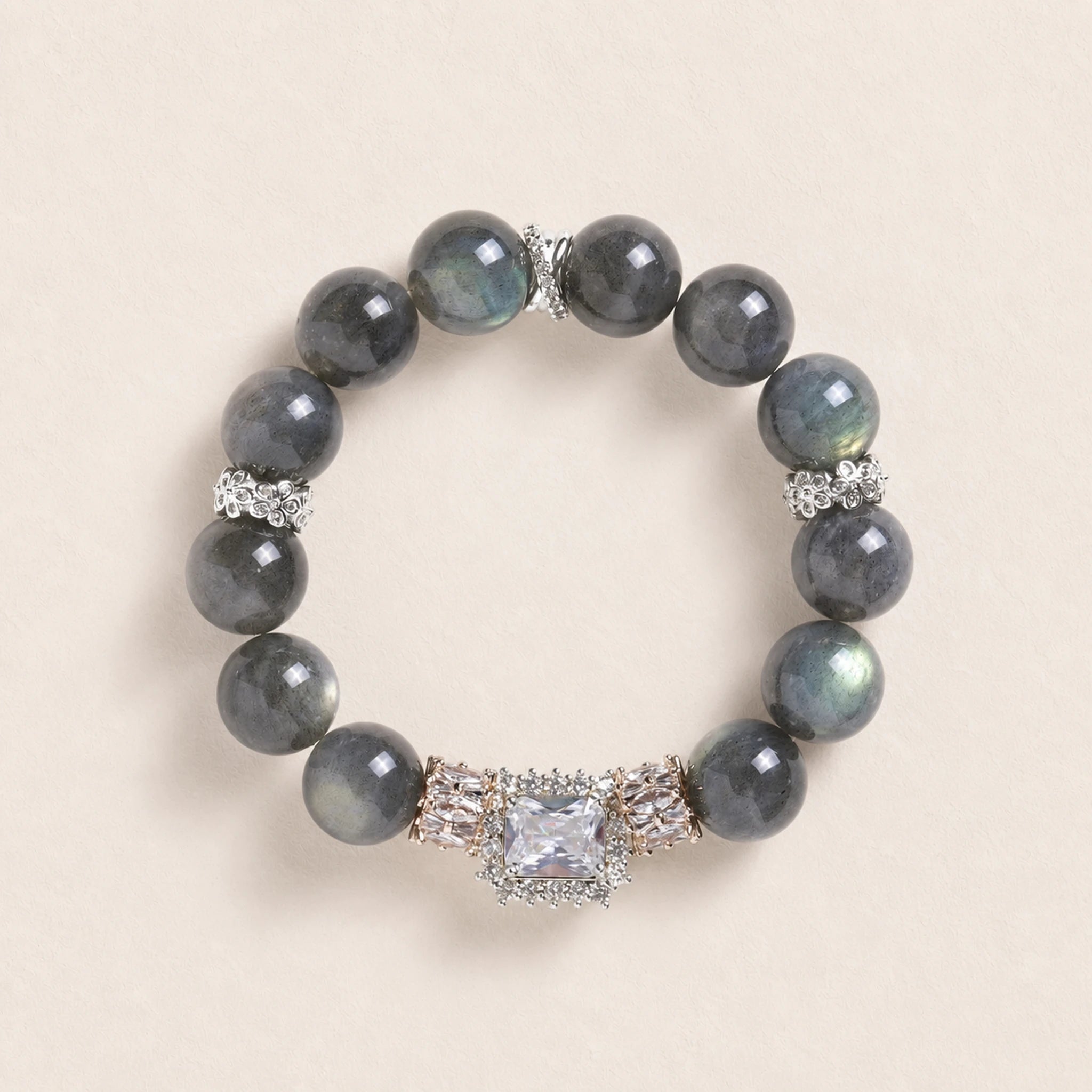 Dark gray iridescent bead bracelet with ornate silver centerpiece and square crystal charm