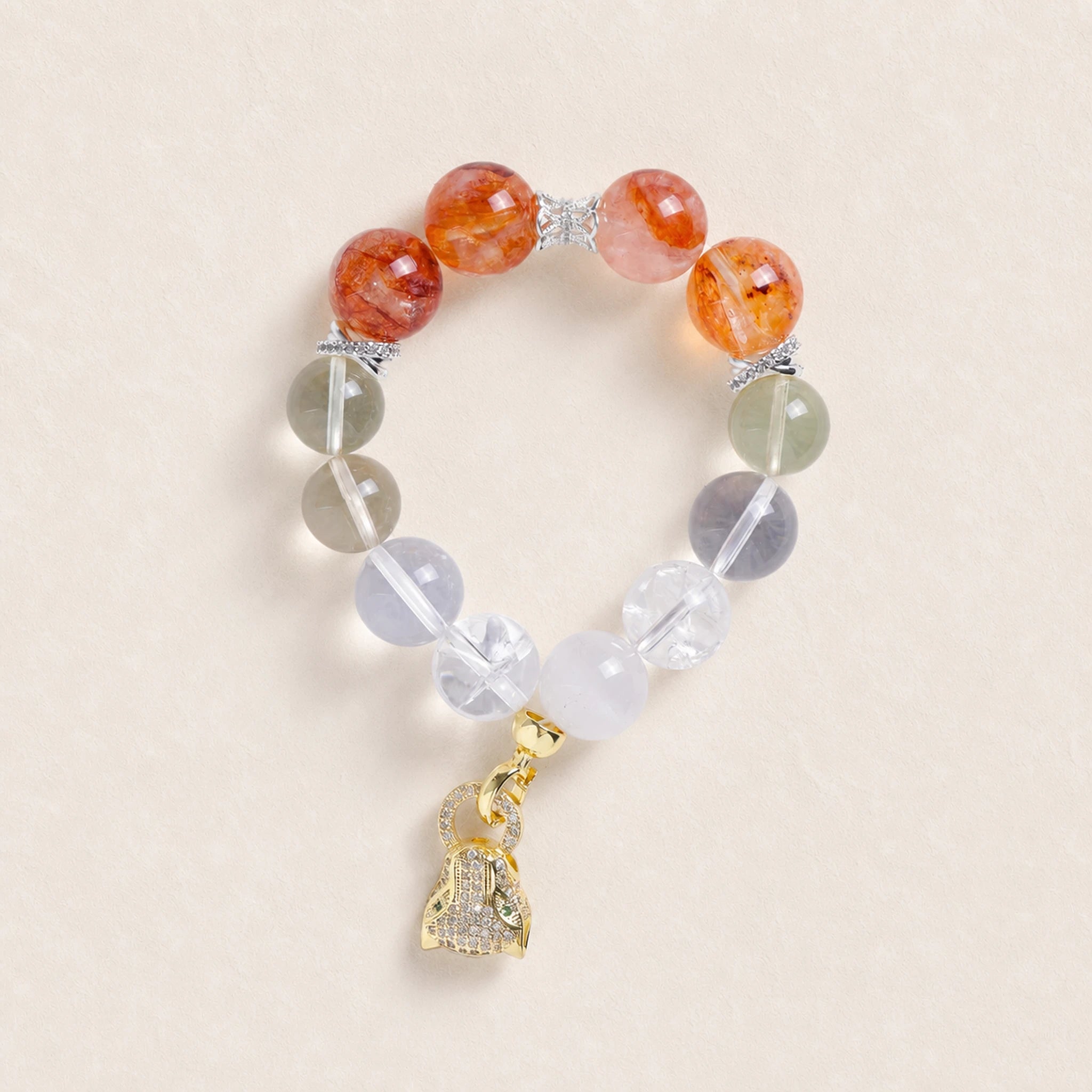 Beaded energy bracelet with orange and translucent gray beads, silver spacers, gold charm