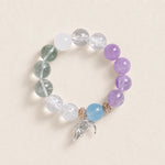Beaded energy bracelet with purple, green, clear and light blue stones, gold tone charm