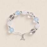Silver-tone beaded bracelet with pale blue and white round beads, featuring a fish charm.