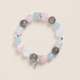 Pastel beaded bracelet with gray, pink, and blue stones; silver toggle and dangling charm.