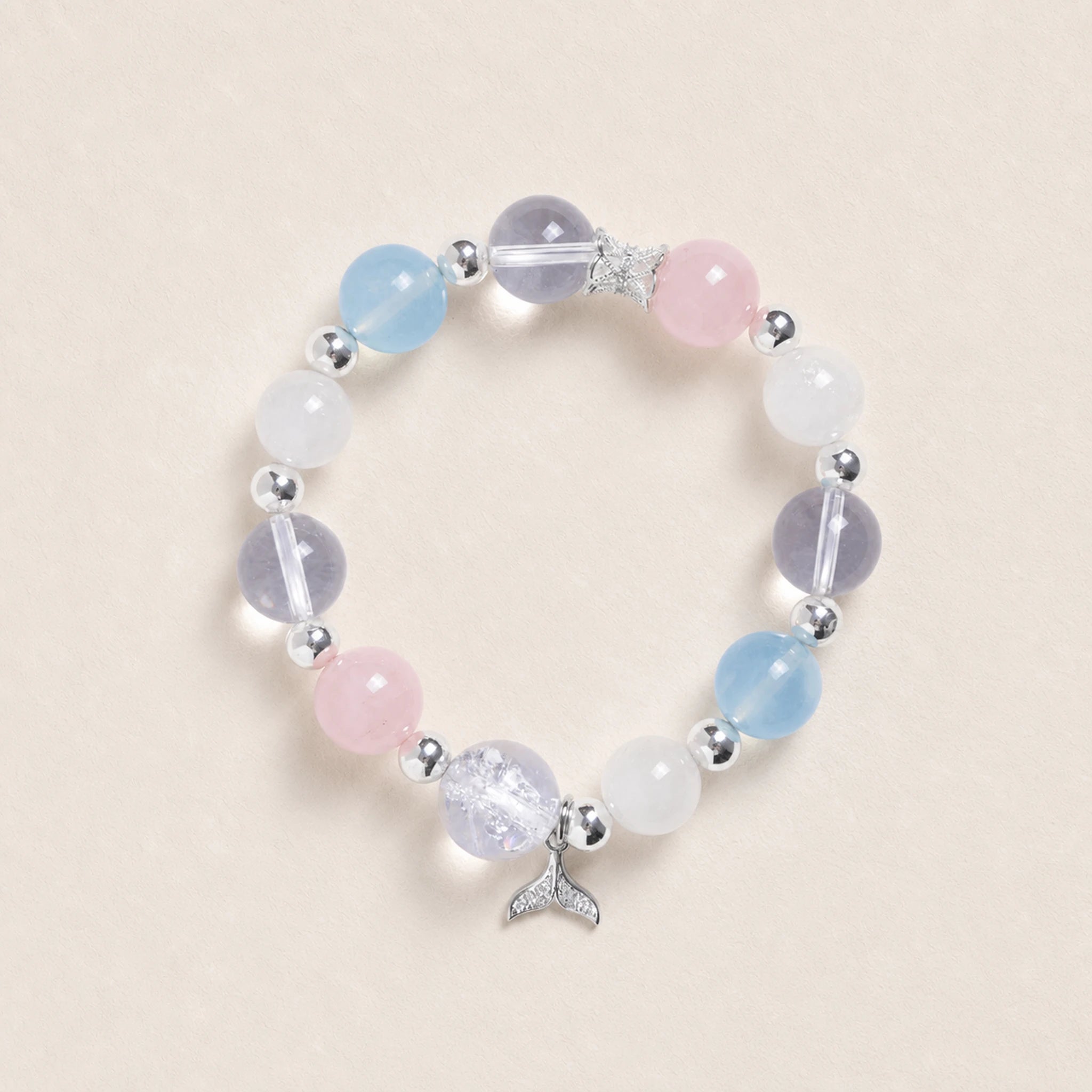 Beaded energy bracelet with pastel light blue, pink, and white stones and silver cup charm