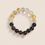 Beaded energy bracelet with black and translucent yellow beads, gold star charm