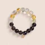Beaded energy bracelet with black and translucent yellow beads, gold star charm