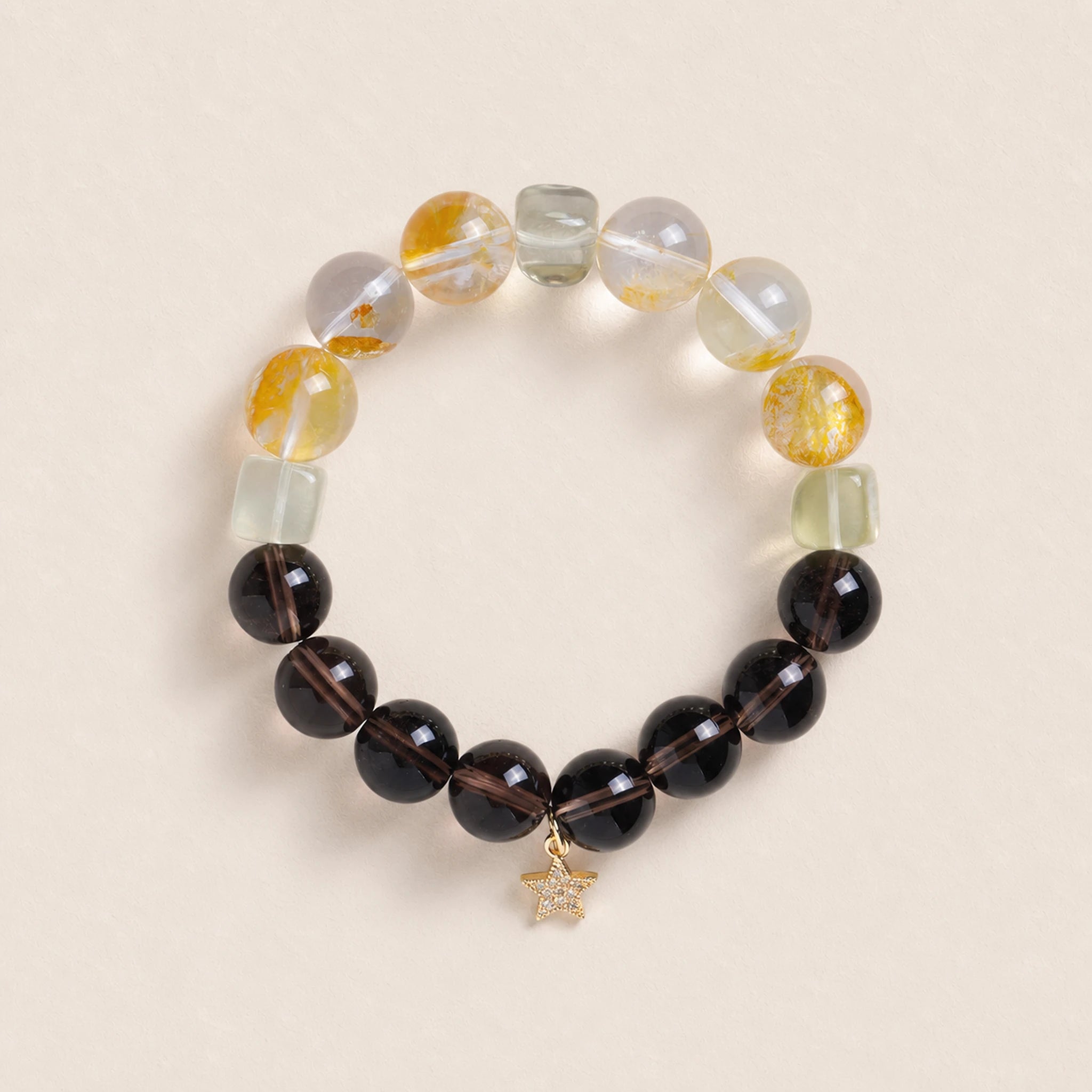 Beaded energy bracelet with black and translucent yellow beads, gold star charm