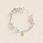 Beaded energy bracelet with star charm and mixed clear, yellow, and light gray stones