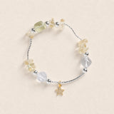 Beaded energy bracelet with star charm and mixed clear, yellow, and light gray stones
