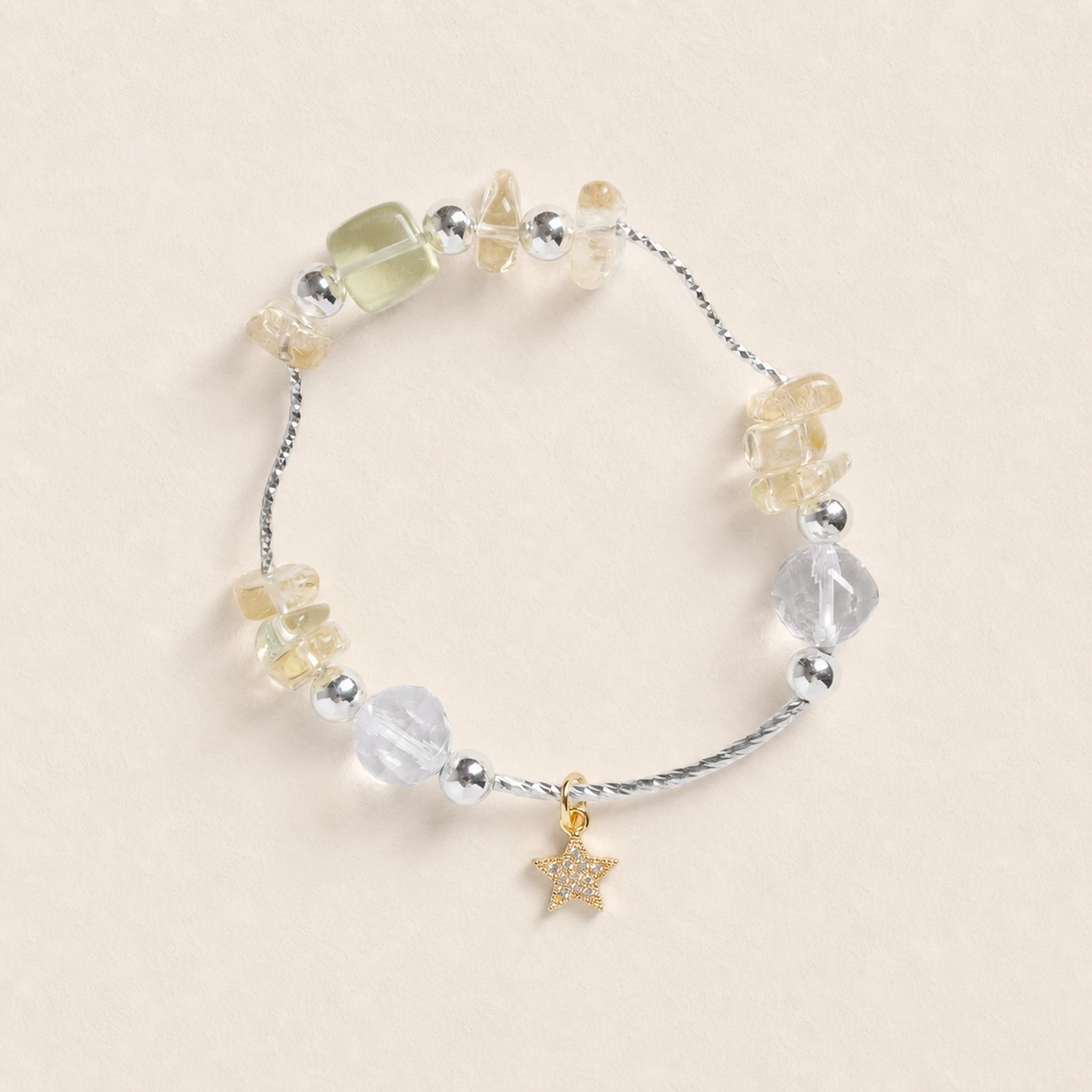 Beaded energy bracelet with star charm and mixed clear, yellow, and light gray stones