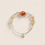 Beaded energy bracelet with amber and clear beads, brown center bead, star charm