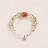 Beaded energy bracelet with amber and clear beads, brown center bead, star charm