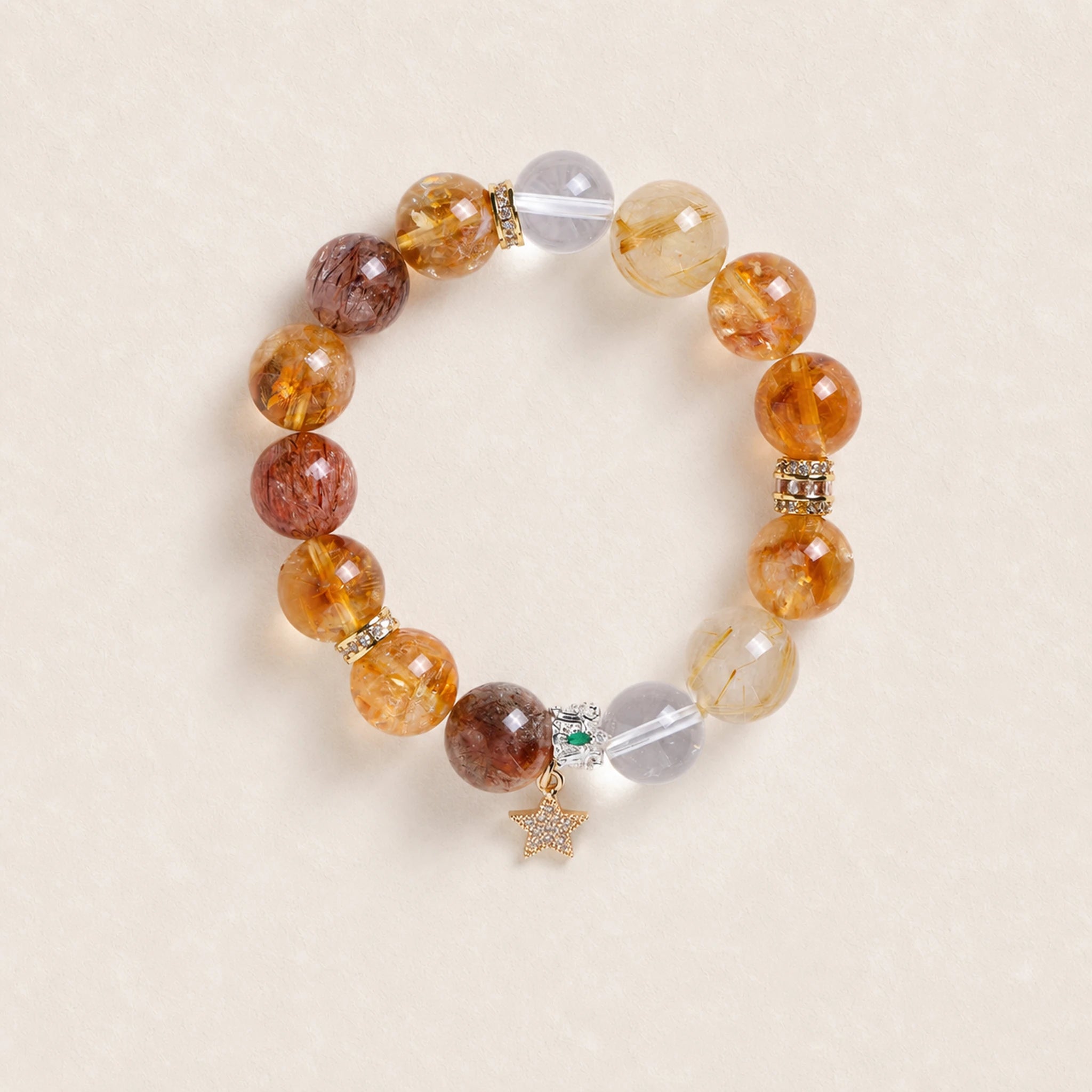 Gemstone beaded bracelet with gold spacers, crystal accents, and star charm.