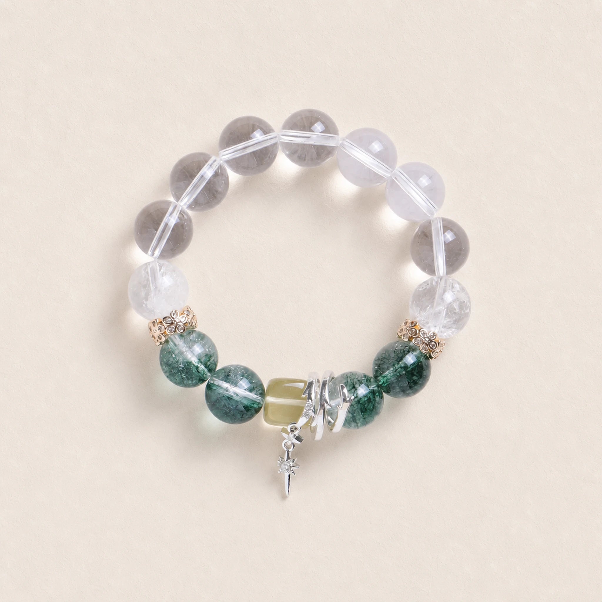 Beaded energy bracelet with clear round stones, green gemstone beads, and silver cross charm