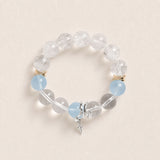 Beaded energy bracelet with clear stones, light blue accents, gold spacers, silver charm