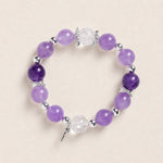 Purple amethyst-style bead bracelet with silver spacers and clear faceted charm