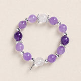 Purple amethyst-style bead bracelet with silver spacers and clear faceted charm