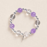 Purple and clear bead energy bracelet with silver spacers and small dangling charm