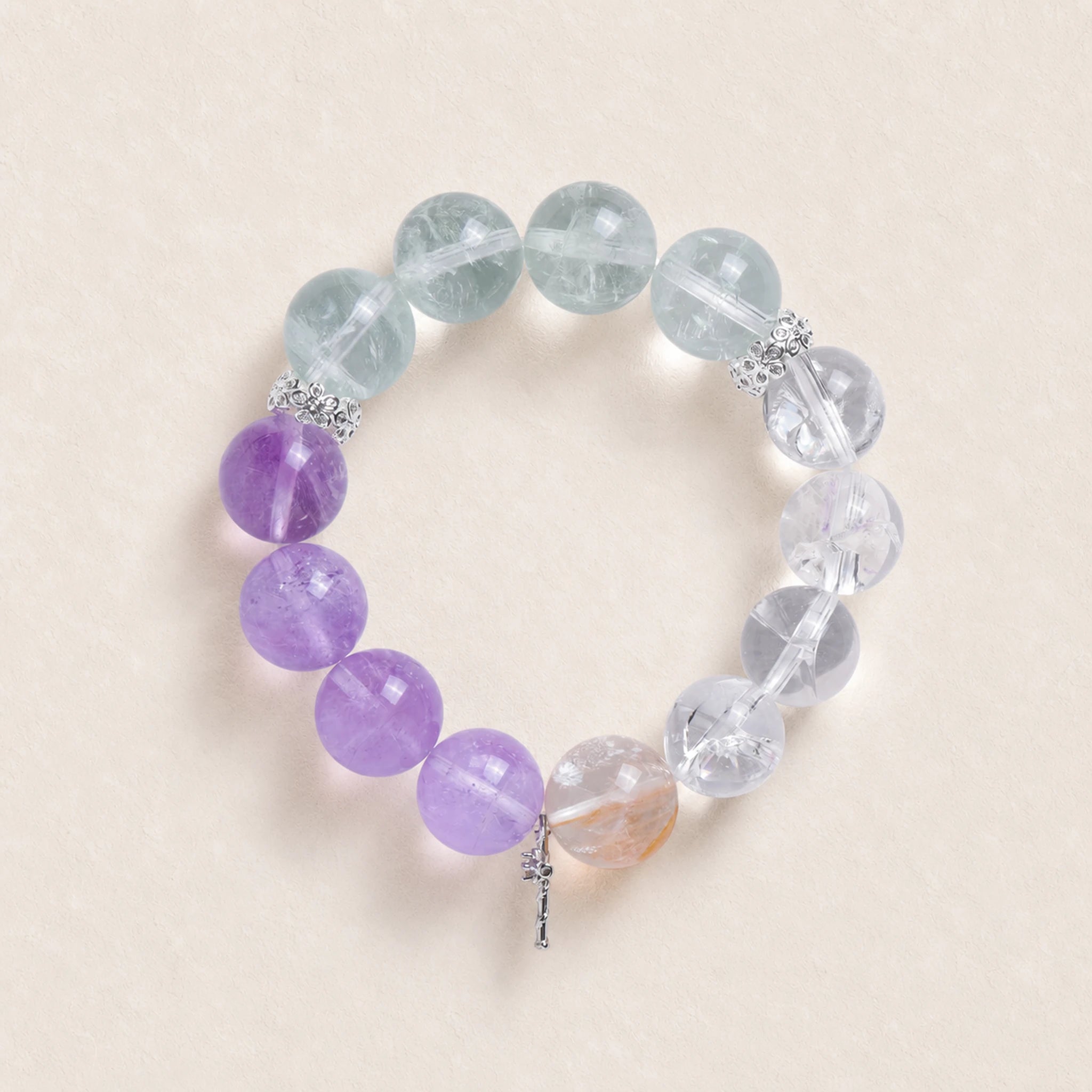 Gemstone beaded charm bracelet with purple and clear round beads and small silver dangle